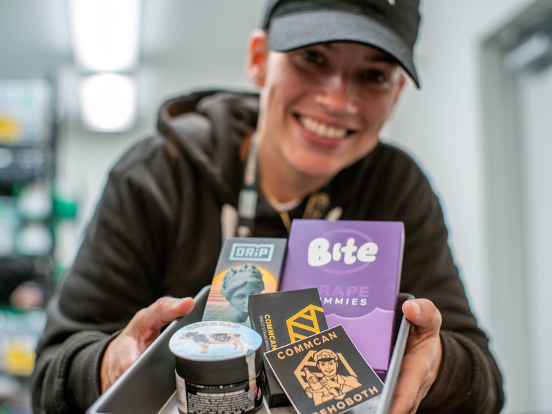 A photograph of Mandi from CommCan's Rehoboth cannabis dispensary prepares an order.